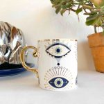 Taza de cerámica con ojos turcos con destellos y asa dorada